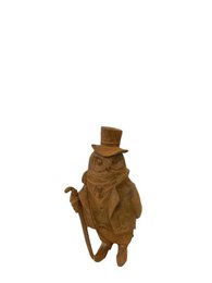  Wooden garden sculpture of an owl-like figure wearing a top hat and holding a cane, made of a warm brown material.