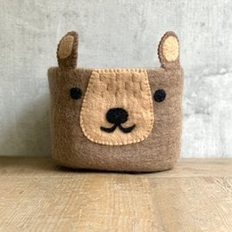 Soft, plush brown bear-shaped basket with cute features for storing items in a child's room.