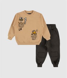 Beige sweatshirt with cartoon character graphics, black cargo pants, kids outfit set.