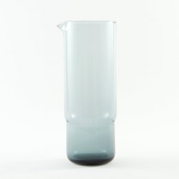 Tall, cylindrical glass carafe with a smoky gray color and a unique swirling pattern on the surface.