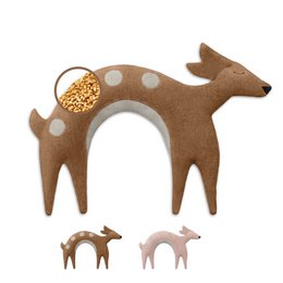 Soft, plush neck pillow filled with organic wheat grains in a variety of warm, earthy colors including beige, orange, dark brown, red, and pink. Shaped like a friendly deer with polka dot accents.