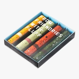 Assorted colorful candy bars in a box, featuring a variety of flavors and textures. The candy bars appear to be rectangular in shape with a layered design.