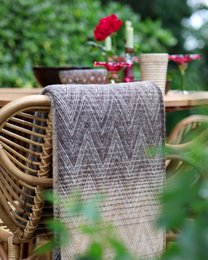 Cozy yellow throw blanket with fringe detail, made of soft, high-quality material for a comfortable and stylish addition to any living space.