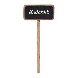 A small chalkboard sign on a wooden stick, with the Dutch word "Bedankt" written on it, which means "Thank you". The sign is placed in a small white pot with a green plant.