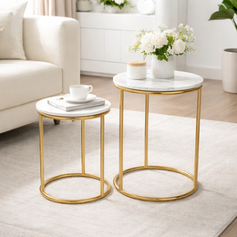 A set of 2 gold-colored side tables with marble tops, suitable for use as end tables or accent pieces in a living room or bedroom.