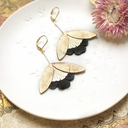Gold and black leather drop earrings with ginkgo flower design.