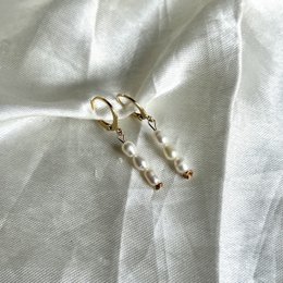 Three gold-toned earrings with pearl accents. Elegant and versatile hoop earrings.