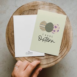 Colorful Easter postcard with floral design and text "Easter" on natural paper background.