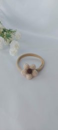 Beige and brown hairband with floral design, suitable for kids.