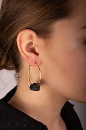 Elegant drop earrings featuring natural lava stone accents in a gold-tone setting.