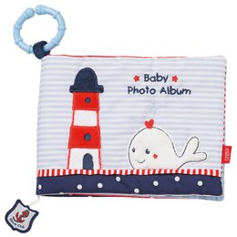 A photo album with a lighthouse and sailboat design, suitable for storing baby photos. The album features a soft, textured material and a teething ring for baby's comfort.