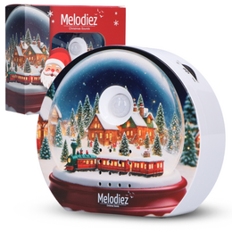 A round, glass snow globe with a winter scene inside, including a Christmas tree, snowman, and Santa Claus. The snow globe has a red base and is surrounded by a snowy landscape with trees and houses.