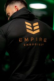 Black unisex hoodie with Empire Embodied logo and high collar. Made of soft, comfortable material suitable for casual wear.
