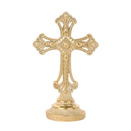 Gold ornate decorative cross with floral details, standing religious figurine, elegant baroque style.
