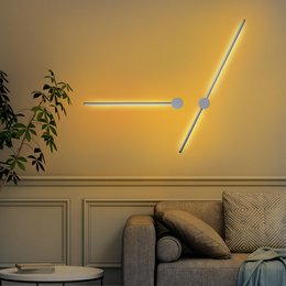  A modern, minimalist LED wall lamp with a sleek, linear design. The lamp features a long, thin light source that creates a warm, ambient glow, perfect for illuminating a living room or bedroom.