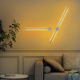 A modern, minimalist LED wall lamp with a sleek, linear design. The lamp features a long, thin light source that creates a warm, ambient glow, perfect for illuminating a living room or bedroom.