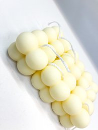 Small pastel yellow bubble candle. Pillar candle with round, bubble-like shape and soft, pale yellow color.