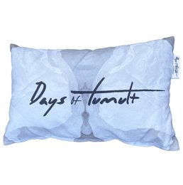 Rectangular outdoor pillow with a blue and white pattern, filled with soft material. The pillow has the text "Days of Tumult" printed on it in a handwritten style.