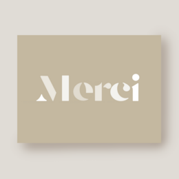 Beige thank you card with the French word "Merci" printed in white text. The card is shown with and without an envelope.