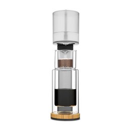 A tall, cylindrical cold drip coffee maker in a classic dark slate grey color. Features a glass carafe and a sleek, modern design.
