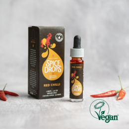 Red chili natural extract, spice drops, oil, vegan. A concentrated, flavorful chili oil with a vibrant red color.