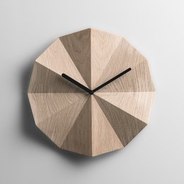 Wooden Delta Clock in Oak, a modern wall clock with a geometric design and available in black or white hands.