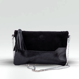 Black varnish clutch bag with tassel detail and chain strap.