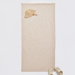 Beige yoga mat with a heart-shaped design, suitable for beach yoga sessions.