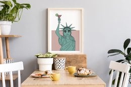 Statue of Liberty wall art featuring a stylized illustration of the iconic landmark. The artwork showcases the Statue's distinctive green color and torch, capturing the symbol of freedom and democracy.