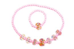 Children's necklace and bracelet set with pink elastic beads, colorful balls, and bows.