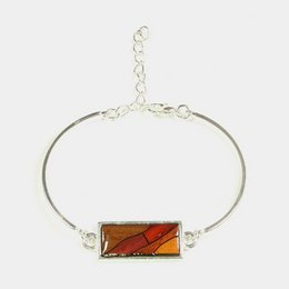 Silver-tone chain bracelet with rectangular amber-colored stone pendant.