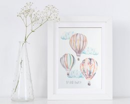 Watercolor hot air balloon children's wall art print featuring colorful hot air balloons floating in a cloudy sky. The print has a whimsical, playful style suitable for a nursery or child's bedroom.
