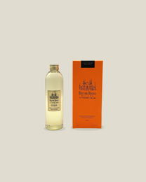 A glass reed diffuser bottle filled with a dark amber-colored liquid, likely the fragrance refill for the Porta Romana Dr. Angeli Milan reed diffuser.