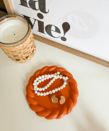 White ceramic leaf-shaped decorative bowl with a textured surface.
