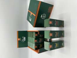 Green and orange display boxes containing CBD Dutch Nova products. The boxes feature the brand's logo and text in French.