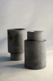 Concrete candelabra in various colors including terracotta, white, and black. Cylindrical shape with a simple, minimalist design.