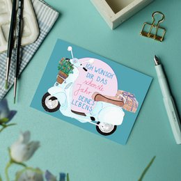  A birthday card featuring a Vespa scooter with a floral arrangement and a handwritten message in German. The card has a retro, whimsical style.