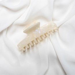 Beige hair claw clip with a simple, elegant design suitable for various hairstyles.