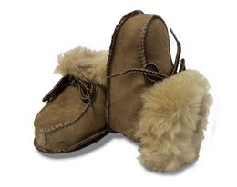 Taupe-colored baby booties with soft, fluffy white lining and leather-like exterior. Suitable for infants and toddlers.