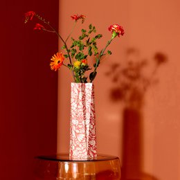 Large papaya-colored vase with abstract geometric patterns in various colors including pink, green, and orange.