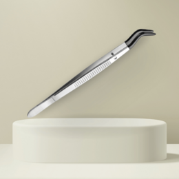 A stainless steel pinzette tool used for baking and decorating. The pinzette has a long, slender shape and a curved tip for precise handling of small items.