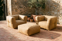 Beige tan upholstered armchair, rounded cubic shape, textured fabric, modern minimalist design, single seat furniture.
