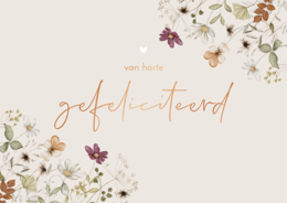 Floral postcard with the text "gefeliciteerd" (congratulations in Dutch) in gold lettering. The card features a delicate arrangement of white and purple flowers against a light background.