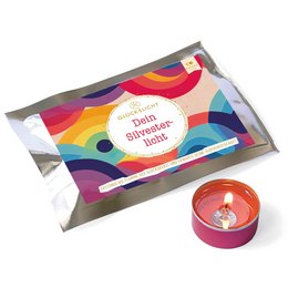 Colorful, round tealight candle in a rainbow-patterned box. The product is described as "Fortuna's Lucky Light" or "Your New Year's Light", indicating it may be a festive or decorative tealight candle.
