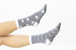 Gray organic cotton split socks with polka dot and striped patterns. Comfortable and breathable for everyday wear.