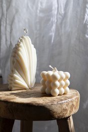 Tall, round white pillar candle with a natural, organic appearance.