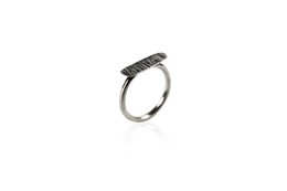 Long silver-toned ring with a round, minimalist design. Made of metal with a textured, hammered finish. Suitable for stacking with other rings.