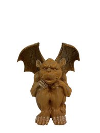 A cast iron garden sculpture of a gargoyle with bat-like wings and a mischievous expression, suitable for outdoor decor.