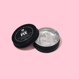 Glitter Fix is a face makeup product in a black circular container. The product appears to be a glitter or shimmer-based makeup item.