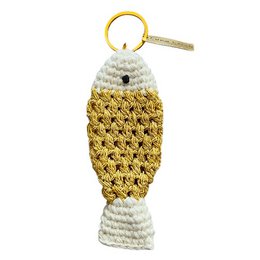  "A handcrafted, crocheted keychain in the shape of a fish, featuring a gold and white color scheme. The keychain is made of organic cotton and lurex, and was hand-crocheted in Nepal."